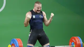 FILE - Oleksandr Pielieshenko, of Ukraine, celebrates after a lift in the men's 85kg weightlifting competition at the 2016 Summer Olympics in Rio de Janeiro, Brazil, on Aug. 12, 2016. The Ukrainian Olympic Committee says two-time European weightlifting champion Oleksandr Pielieshenko has died on the front line in the war in Ukraine. (AP Photo/Mike Groll, File)