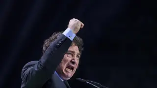 Argentina's president Javier Milei gestures as he delivers a speech on stage during the Spanish far-right wing party Vox's rally "Europa Viva 24" in Madrid, Spain, Sunday, May 19, 2024. VOX has invited speakers from across the right wing spectrum including Marine Le Pen, Viktor Orban and Argentine President Javier Milei who has been visiting Spain since Friday. (AP Photo/Manu Fernandez)