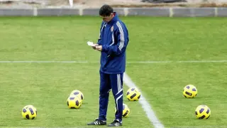 José Aurelio Gay revisa unas notas en su agenda, durante el entrenamiento que dirigió ayer en la Ciudad Deportiva.