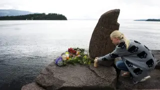 Una joven enciende una vela en recuerdo por los fallecidos en la isla de Utoya