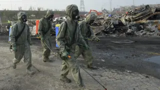 Varios soldados del Ejército de la Liberación del Pueblo de China trabajan para neutralizar los residuos de cianuro de sodio en Tianjin.