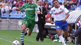 Luis César Sampedro, en segundo término delante de su banquillo en La Romareda, el 6 de octubre de 2002 en un Real Zaragoza-Racing de Ferrol. Juanele intenta desbordar al defensor gallego.