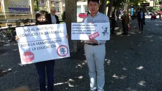 Dos miembros de la plataforma muestran carteles contra el Instituto Confucio.