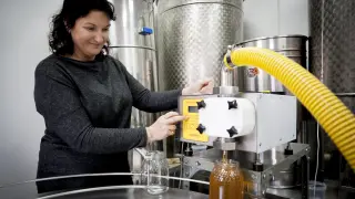 Mari Carmen Sancho envasa un tarro de kilo de miel en el obrador de Peñas Blancas.