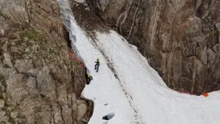 Especialistas de los grupos de montaña durante el rescate del montañero fallecido ayer al caer 100 metros por una canal de nieve.