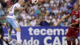 Pombo (24 años) remata de cabeza ante Krohn-Dehli (35 años) en el Real Zaragoza-Deportivo de La Coruña de Copa jugado en septiembre en La Romareda.