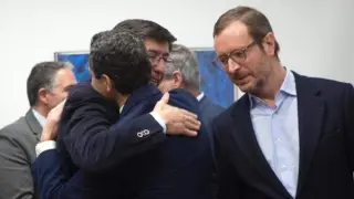 Juanma Moreno y Juan Marín se abrazan al inicio de la reunión.