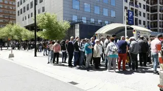 Ciudadanos rumanos haciendo fila frente al consulado para votar, hoy, en Zaragoza.