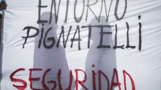 María y Pilar, tras una de las pancartas que se desplegaron en la plaza del Pilar de Zaragoza durante la protesta de los vecinos de Pignatelli.