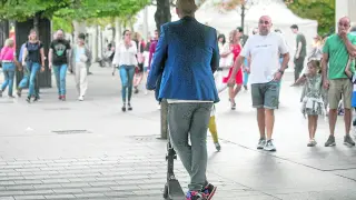 Un usuario de patinete circula de forma irregular por la acera de la plaza de Aragón.