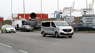 Un furgón fúnebre abandona el puerto de Tilbury escoltado por la Policía.