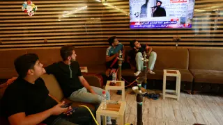 Jóvenes iraquíes siguen por televisión la noticia de la muerte de Al Bagdadi.