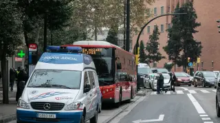 El autobús implicado en el atropello, cerca de la zona del accidente, entre dos coches de la Policía Local de Zaragoza.