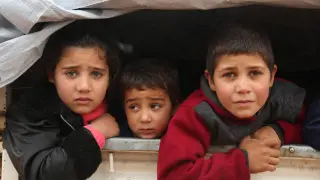 Niños sirios desplazados son transportados en una camioneta el pasado 3 de enero tras escapar de la violencia en la ciudad de Maarat-al-Numan.