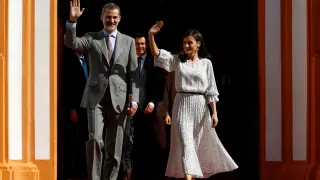 FILE PHOTO: Spain's King Felipe VI and Queen Letizia wave during their visit to Almonte, southern Spain