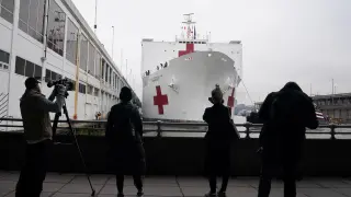 Members of the media are pictured as the USNS Comfort pulled into a berth in Manhattan during the outbreak of coronavirus disease (COVID-19), in the Manhattan borough of New York City