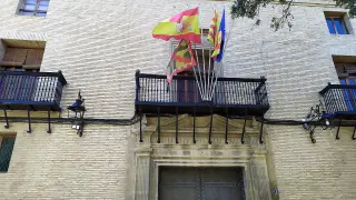 Banderas a media asta y un crespón negro en la enseña de Huesca como señal de luto.