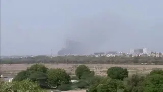 A plume of smoke is seen after the crash of a PIA aircraft in Karachi