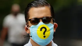 Man wears a protective face mask decorated with a question mark during outbreak of the coronavirus disease (COID-19) in New York