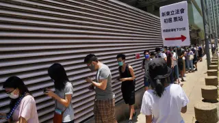 People line up to vote in the primary election aimed at selecting democracy candidates for the September election, in Hong Kong