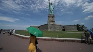 People are seen at the Statue of Liberty as New York enters Phase 4 of reopening following the outbreak of the coronavirus disease (COVID-19) in New York City