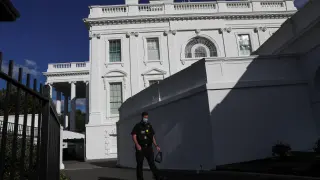 U.S. Secret Service officer walks past White House residence where President Trump remains in quarantine after testing positive for COVID-19 in Washington