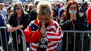 People pray for U.S. President Donald Trump, who was diagnosed with the coronavirus disease (COVID-19), in New York City