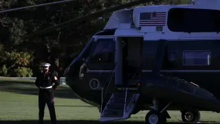 U.S. Marine waits by Marine One for U.S. President Trump to depart for Walter Reed Medical Center at the White House in Washington