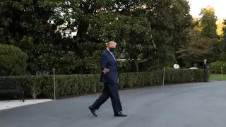 U.S. President Trump waves while walking to the Marine One helicopter as he departs for Walter Reed Medical Center from the White House in Washington