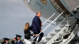 FILE PHOTO: U.S. President Donald Trump boards Air Force One with first lady Melania Trump at Palm Beach International Airport in Florida