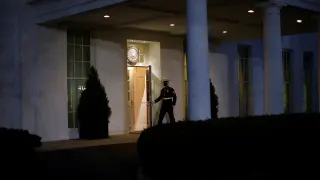 A U.S. Marine opens a door of the West Wing door, an indication that U.S. President Donald Trump is in the Oval Office during his last day in office, in Washington U.S.