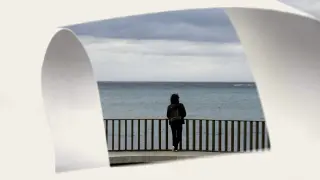 Una persona observa el mar desde el paseo marítimo de La Coruña