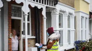 Volunteers hand out COVID-19 home test kits in Ealing, London