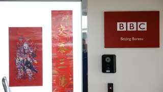 A placard with the BBC logo is seen outside their bureau in Beijing