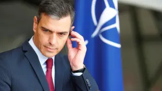 Spanish Prime Minister Pedro Sanchez listens during news conference in Siauliai air base