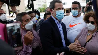 Venezuela's opposition leader Juan Guaido greets people, in Caracas