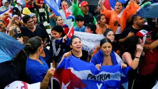 Emigres in the Little Havana neighborhood react to reports of protests in Cuba against its deteriorating economy, in Miami