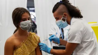 Martina Alvarez, 12 years old, receives a dose of the Pfizer-BioNTech vaccine amid the coronavirus disease (COVID-19) pandemic at Fira Barcelona