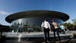 FILE PHOTO: Guests arrive for at the Steve Jobs Theater for an Apple event at their headquarters in Cupertino
