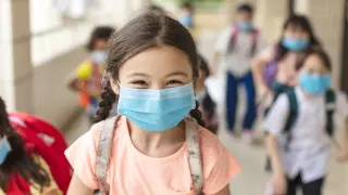 children wearing  face medical mask back to school after covid-19 quarantine