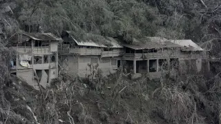 Damaged houses affected by the eruption of Mount Semeru volcano are seen in Pronojiwo village