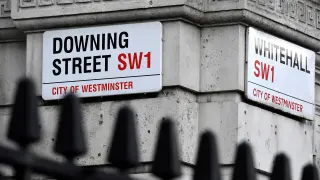 Street signs are seen at the corner of Downing Street, the official residence of British Prime Minister Boris Johnson, in London