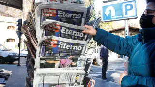 The owner of a newspapers kiosk place new ones at her stand the day after Rafa Nadal won his 21st Grand Slam tournament in Australia