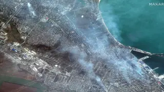 A satellite image shows buildings on fire in Mariupol