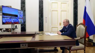 Russian President Vladimir Putin watches a test launch of the Sarmat intercontinental ballistic missile, via video link in Moscow