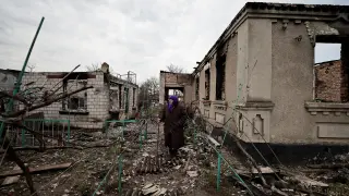 Hanna Chaika, 80, walks by her neighbour's house, that according to her was hit by rockets, amid Russia's invasion of Ukraine, in Ozera, Kyiv region, Ukraine April 23, 2022. REUTERS/Zohra Bensemra UKRAINE-CRISIS/