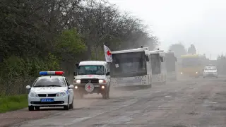 A convoy carrying evacuees from Mariupol area is seen on a road in the Donetsk Region