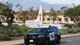A police car is seen after a deadly shooting at Geneva Presbyterian Church in Laguna Woods