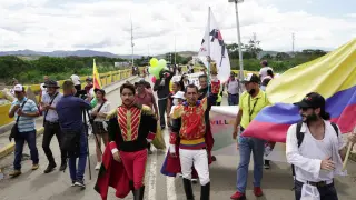 People cross the Simon Bolivar International Bridge on the border between Colombia and Venezuela to attend a political event in San Antonio del Tachira during the swearing-in ceremony of Colombia's President-elect Gustav