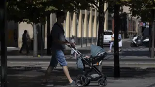 Imagen de archivo de un hombre paseando con un carrito de bebé.